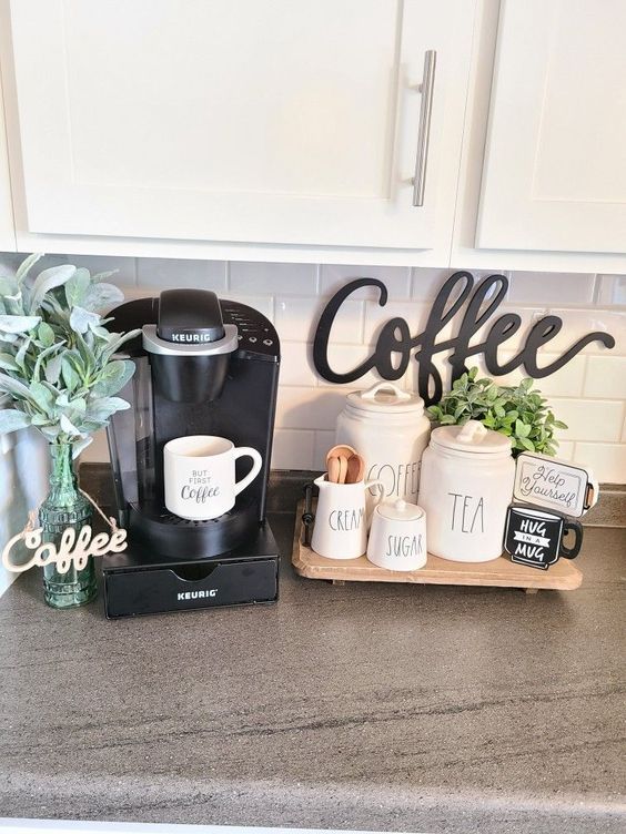 a coffee maker sitting on top of a kitchen counter next to a cup holder and potted plant