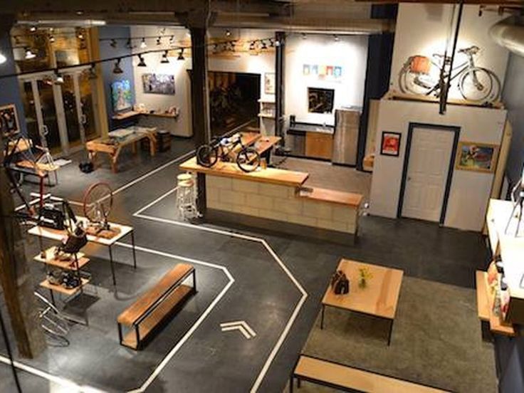 the inside of a bike shop with tables and benches