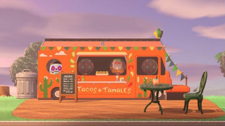 an orange food truck parked in front of a green table and chair next to a trash can