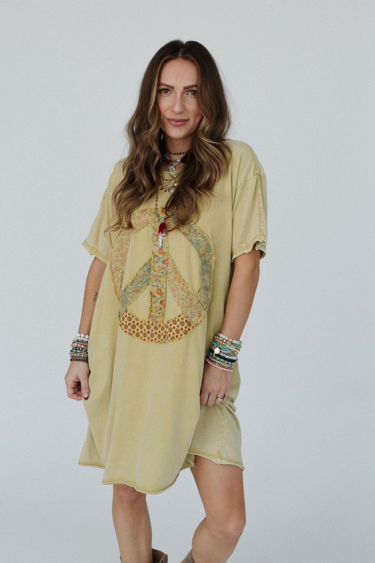 Calling all of our peace gals, we have the top for you; the Retro Peace Tunic Top is so boho cozy with a fun design you'll get so many compliments in! This will be the tunic top you always want to wear because it features: Comfortable, mineral - washed, Cotton jersey fabric Relaxed and loose tunic tee shirt dress silhouette Classic ribbed crew neckline and dropped shoulders with loose short sleeves So cute peace sign patch along the center with mixed floral prints Exposed seams with raw edges th Free Size Short Sleeve Casual Tops, Casual Short Sleeve Tops Free Size, Casual Short Sleeve Free Size Tops, Casual Free Size Short Sleeve Tops, Bohemian Fall Festival Tunic, Bohemian Tunic For Fall Vacation, Bohemian Cotton Tops For Loungewear, Bohemian Cotton Tops For Fall, Free-spirited Tops For Fall Vacation