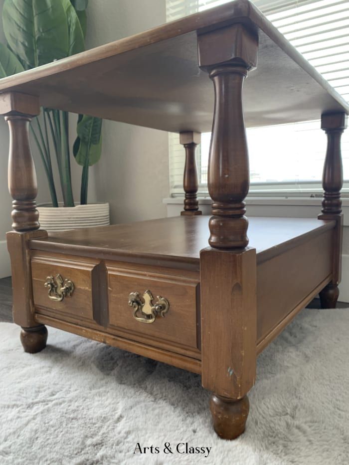 a wooden bed frame with two drawers on each side and an open drawer underneath it