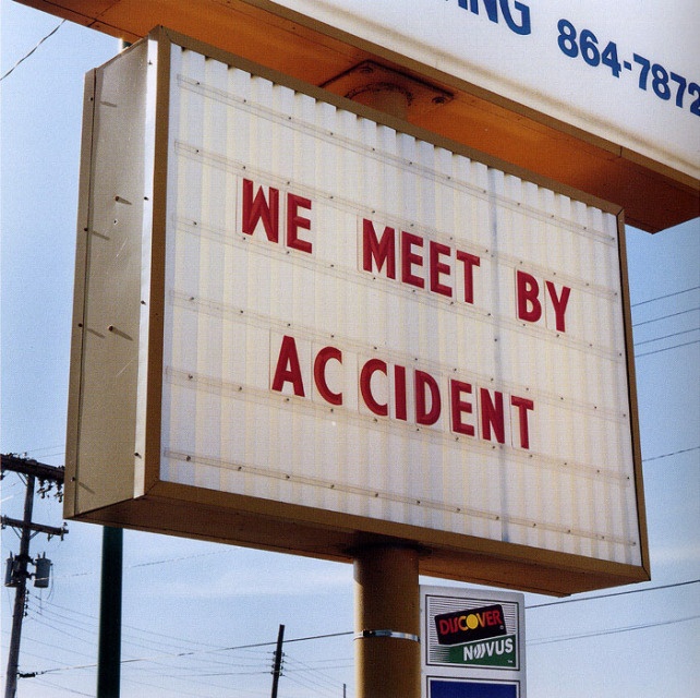 a sign that says we meet by accident