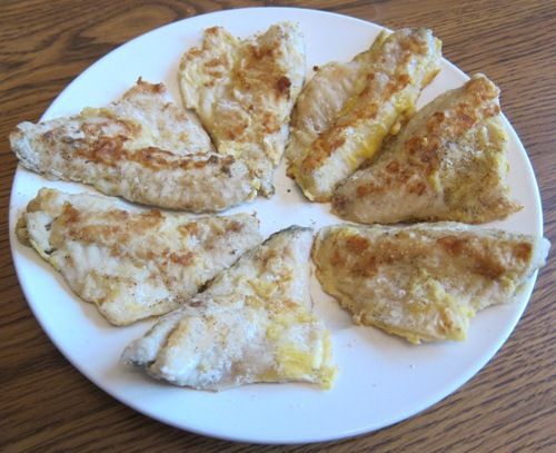 some food is on a white plate on a wooden table and ready to be eaten