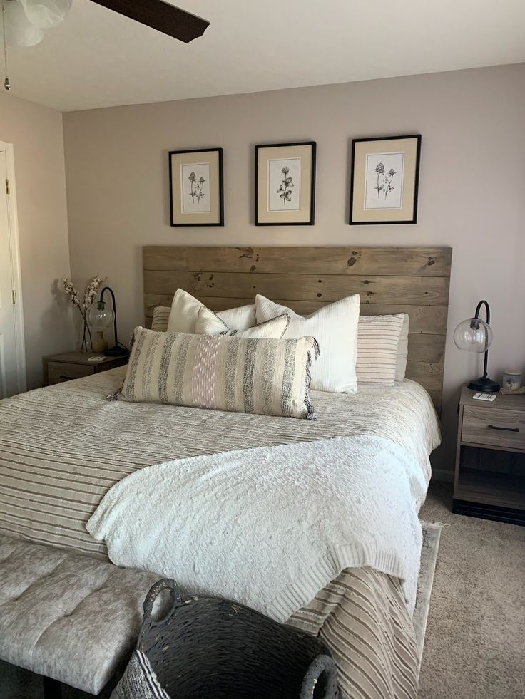 a large bed sitting in a bedroom next to two pictures on the wall above it