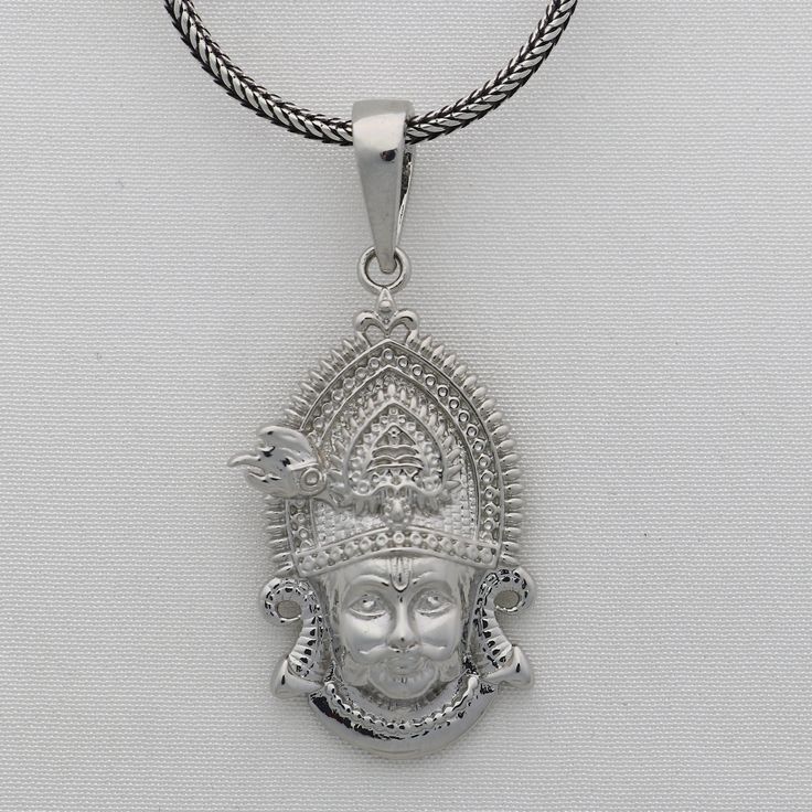 Khatu Shyam's teachings emphasize the importance of karma, devotion, and surrender. He is also known as Shyam, Barbarik, Khatushyam, Morvi Nandan, and Sheesh Ke Dani Metal-925 sterling silver. Item type-Pendant/ Locket Weight-7.040 grams. Height-4.5 centimetre. Width-1.9 centimetres. Stamped-925. Chain details:(if buyer wants to purchase) Chain width-1.5mm(if buy) Weight-12.500 to 18.500 grams(weight vary as per length) Chain Type-screw chain/ pendant chain. Sterling Silver Amulet Necklace For Puja, Sterling Silver Amulet Necklaces For Puja, Spiritual Hallmarked Oval Pendant Jewelry, Spiritual Sterling Silver Necklaces For Rituals, Spiritual Hallmarked Pendant Jewelry, Sterling Silver Large Pendant Jewelry For Rituals, Sterling Silver Jewelry With Large Pendant For Rituals, Spiritual Oxidized Pendant Jewelry, Spiritual Pendant Jewelry With Oxidized Finish