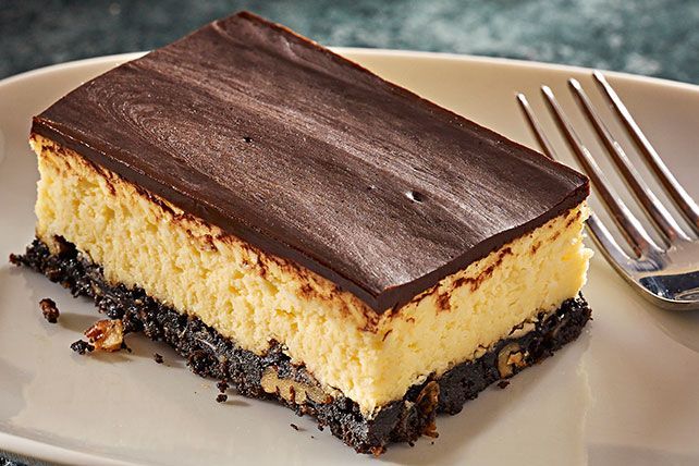 a piece of cake sitting on top of a white plate with a fork next to it