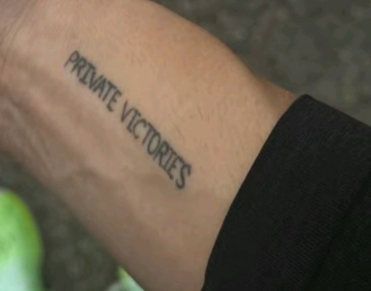 a person with a tattoo on their arm that says private stories