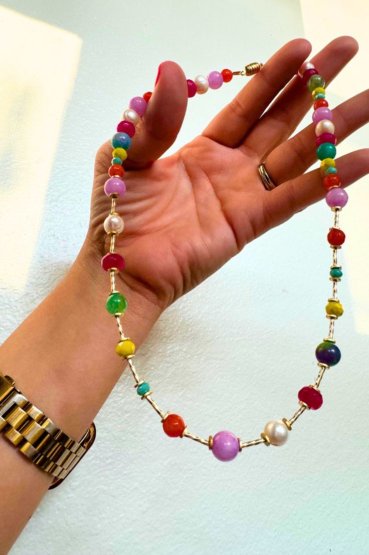 Make a bold and unforgettable impression with our multi-stone beaded necklace with gold spacers. This stunning statement piece showcases an array of vibrant, hand-selected gemstones, elegantly interspersed with gleaming gold spacers to create a harmonious and eye-catching design. Perfect for adding a pop of color and luxury to any outfit, this necklace is a true work of art. Necklace is 18" long gold plated findings natural gemstone beads Available with silver findings as well! Multicolor Round Spacer Beads Jewelry, Rainbow Polished Round Bead Jewelry, Elegant Multicolor Beaded Necklaces With Spacer Beads, Multicolor Spiritual Jewelry With Large Beads, Spiritual Multicolor Jewelry With Large Beads, Rainbow Jewelry With Large Beads For Jewelry Making, Spiritual Multicolor Spacer Beads Jewelry, Colorful Beaded Elegant Jewelry, Multicolor Rondelle Beads Jewelry