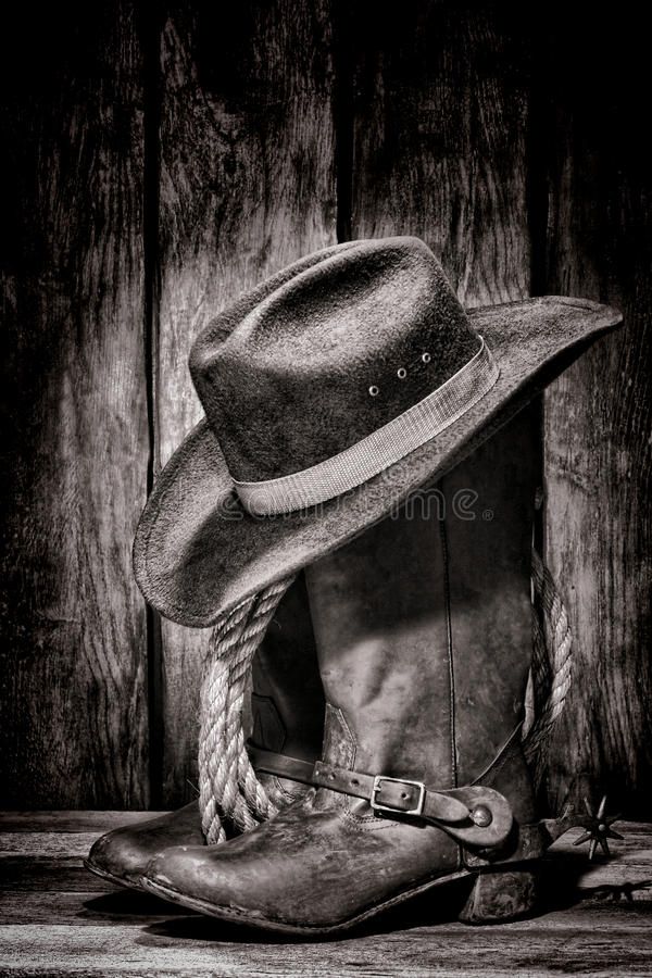 an old cowboy hat and boots on a wooden background royalty images, black and white pictures