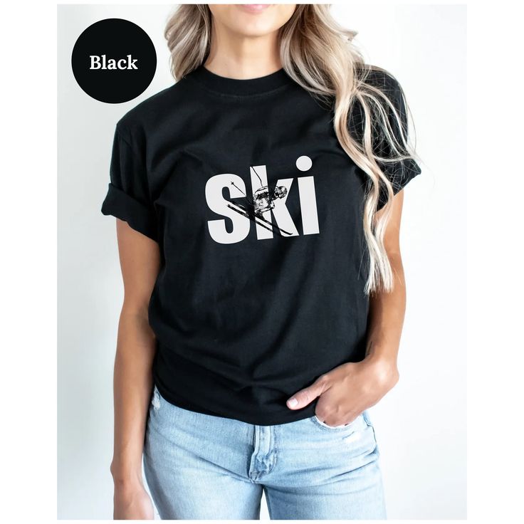 a woman wearing a black ski t - shirt with the word ski printed on it