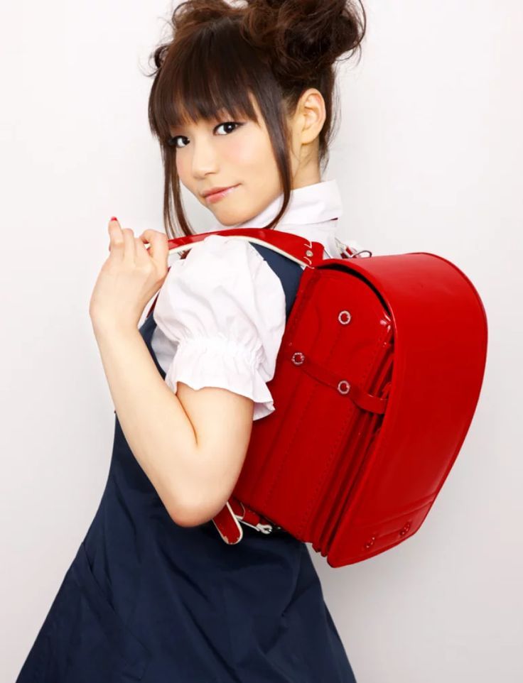 a girl with a red backpack on her back