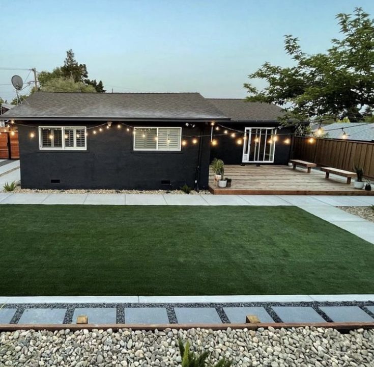 a backyard with grass and lights on it