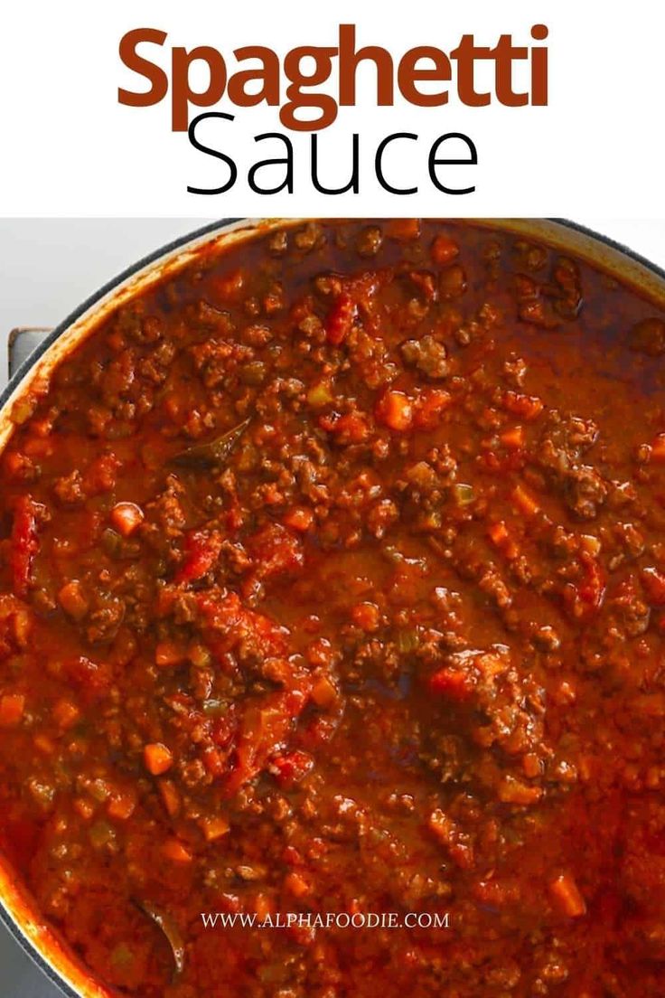 a large pot full of spaghetti sauce on top of a stove with the words spaghetti sauce above it