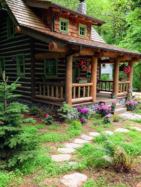 a log cabin in the woods surrounded by flowers