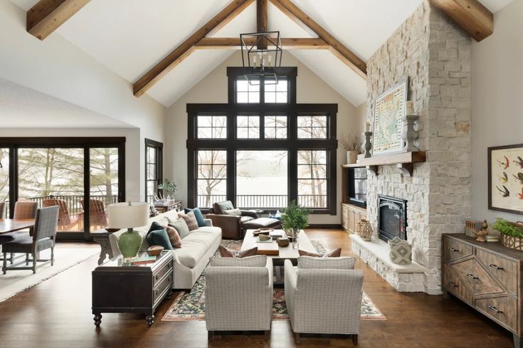 a living room filled with furniture and a fire place in the middle of an open floor plan