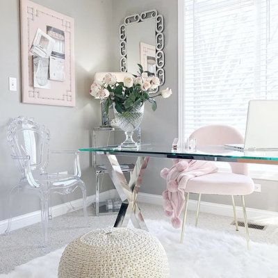 a room with a glass table and white chairs