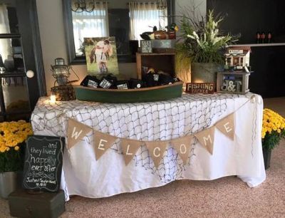 a welcome sign is displayed on a table with flowers and candles in front of it