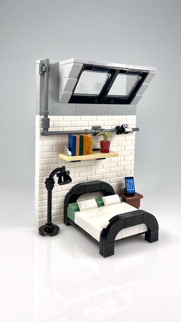 a bed with a book shelf above it and a lamp on the wall next to it