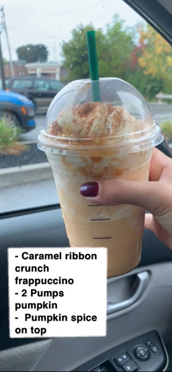 a person holding up a cup of coffee in their hand with the caption caramel ribbon crunch frapuccino pumpkin and pumpkin spice on top