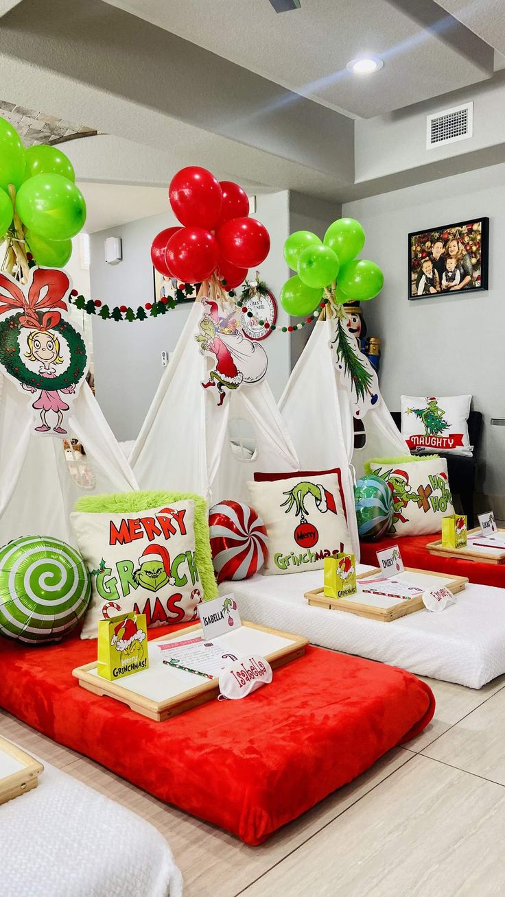 a christmas themed table with balloons and decorations