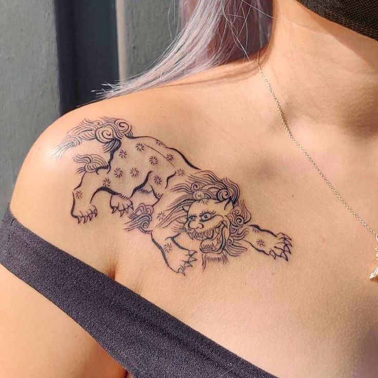 a woman with a tattoo on her shoulder