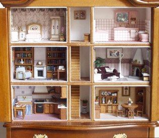 a doll house with furniture and accessories in it's wooden display case on top of a dresser