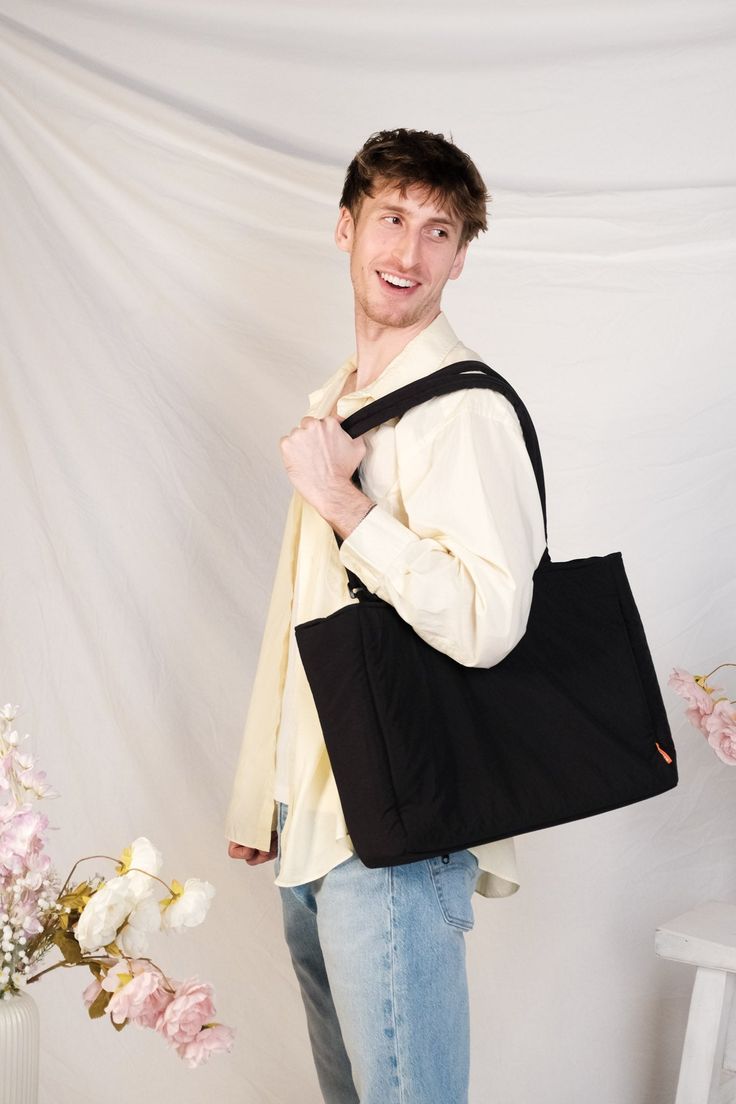 Product Description Made with 100% Nylon Length 40 cm x Height 32 cm x Width 14 cm Inner pocket with zipper (25 x 17 cm) 2 inner pockets without zipper (12.5 x 17 cm) Handle 48-92 cm (adjustable) Outer zippered side pocket (26 x 18 cm) Outer zippered back pocket (40 x 22cm) Outer zippered suitcase slot (20 cm wide) Padded laptop pocket (fits up to a 16in. laptop) Water resistant Nylon Tote Diaper Bag With Zipper Pocket, Nylon Diaper Bag Tote With Zipper Pocket, Nylon Diaper Bag With Zipper Pocket, Tote Style, Rectangular Nylon Canvas Bag For Travel, Everyday Nylon Bag With Laptop Sleeve, Casual Black Laptop Bag With Pockets, Versatile Black Shoulder Bag With Laptop Sleeve, Solid Color Travel Bag With Pockets For Everyday Use, Nylon Bag With Laptop Sleeve For Daily Use