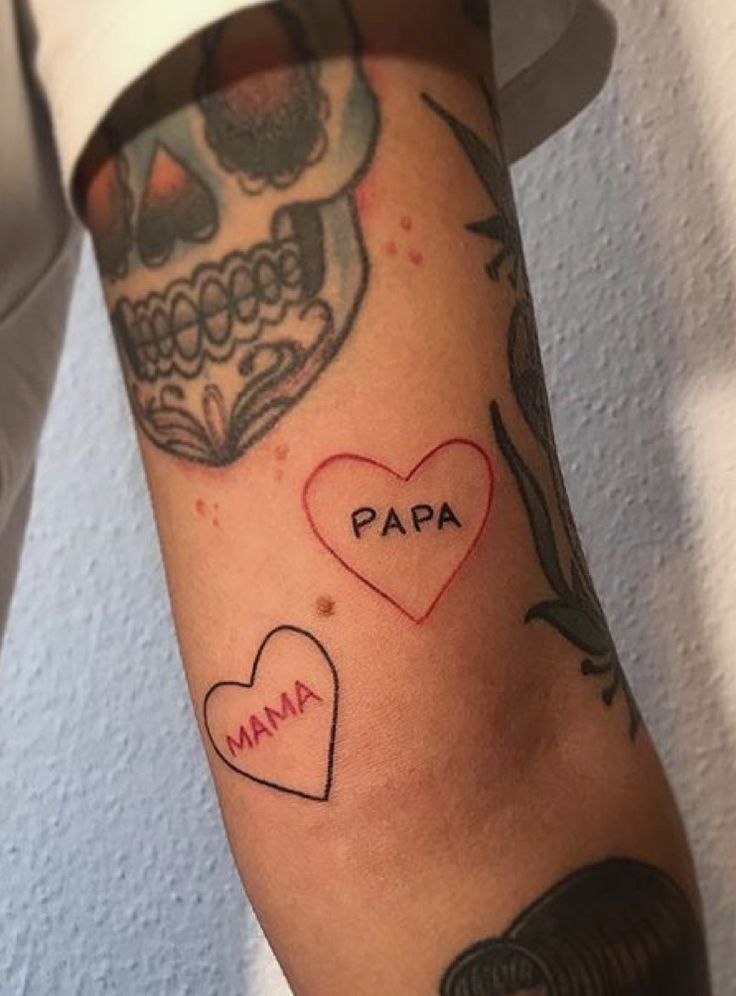 a person with a tattoo on their arm that says papa and a heart in the middle