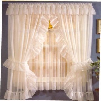 a white curtain with ruffles hanging from it's side in front of a window