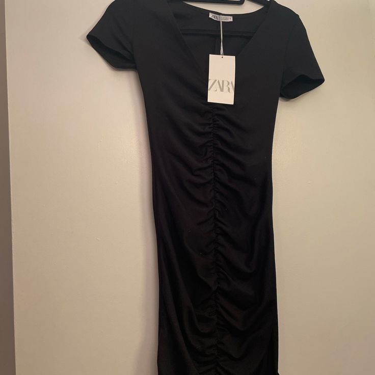 Zara Black T Shirt Dress With Rouching Detail Down The Center. Brand New With Tags, Never Worn Black Ruched Dress With Short Sleeves, Zara Black Casual Midi Dress, Black Short Sleeve Ruched Dress, Casual Black Ruched Mini Dress, Casual Black Mini Dress By Zara, Zara Ruched Short Sleeve Mini Dress, Zara Short Sleeve Ruched Mini Dress, Zara Short Sleeve Mini Dress With Ruched Detail, Zara Casual Black Mini Dress