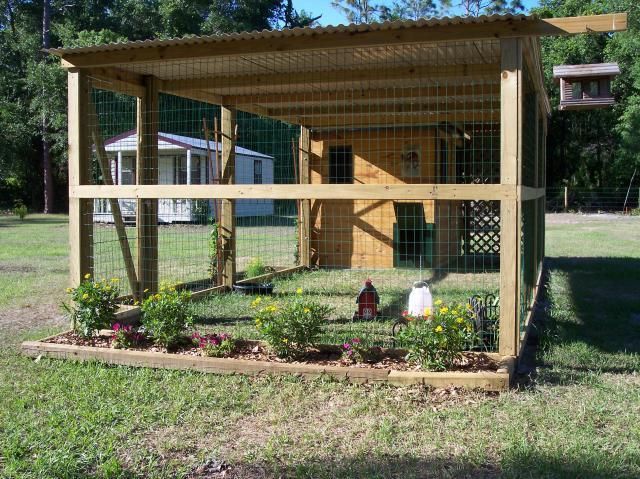 a small chicken coop in the middle of a yard