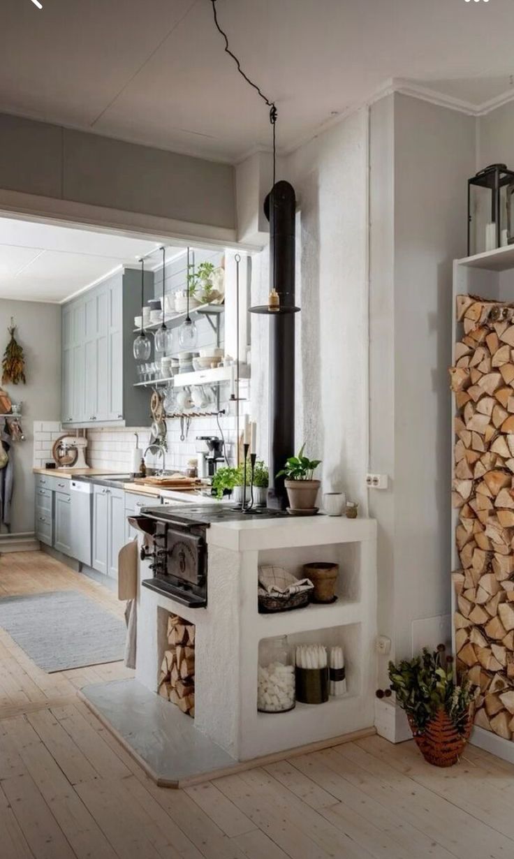 a kitchen filled with lots of wood stacked on top of it's counters and shelves