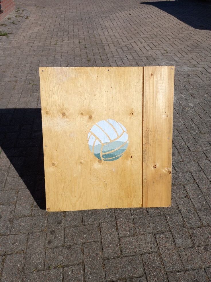 a wooden box sitting on top of a brick sidewalk