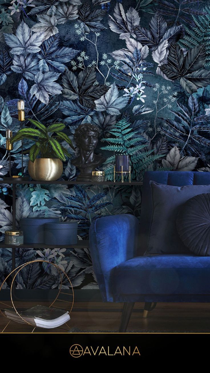 a blue chair sitting in front of a wall covered in plants and leaves on it