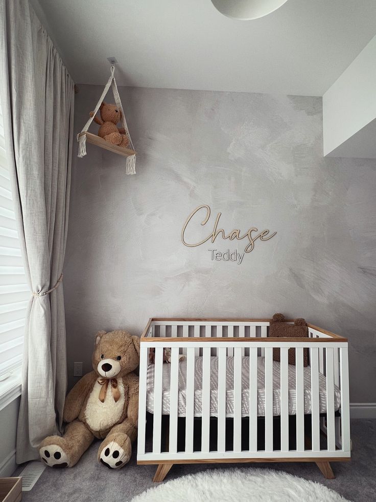 a baby's room with a crib and teddy bears