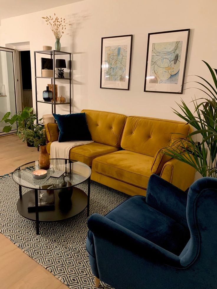 Looking for living room inspiration? This is how I styled my mini apartment. Velvet Sofa is from slf24, velvet armchair and wool carpet are otto.de. Round side table and shelf are from ikea. Wall art is self made. Follow for more inspo. 🧡 Mustard Green Couch Living Room, Tony Living Room Ideas, Yellow Arm Chair Living Room, Living Room Ideas Yellow And Grey, Color Palette For Small Apartment, Mustard Cushions Living Room, Mustard Color Couch, Mustard Armchair Living Rooms, Mustard Chair Living Room