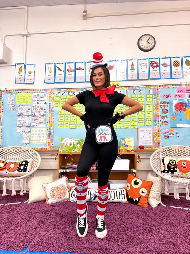 a woman dressed as a cat in the hat posing for a photo with her hands on her hips