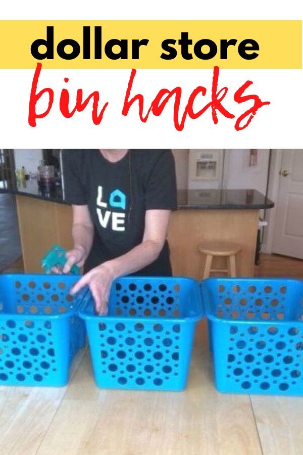 three blue plastic baskets sitting on top of a wooden table next to a woman in a black shirt