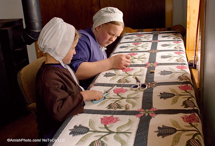 two women are working on a quilt together