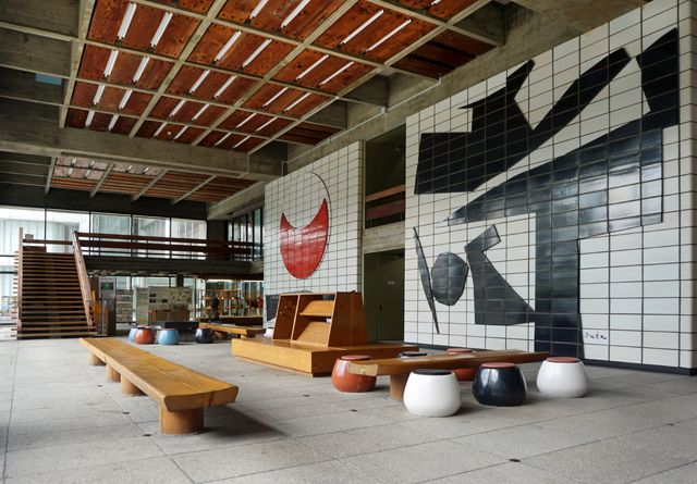 an empty room with benches and tiled walls