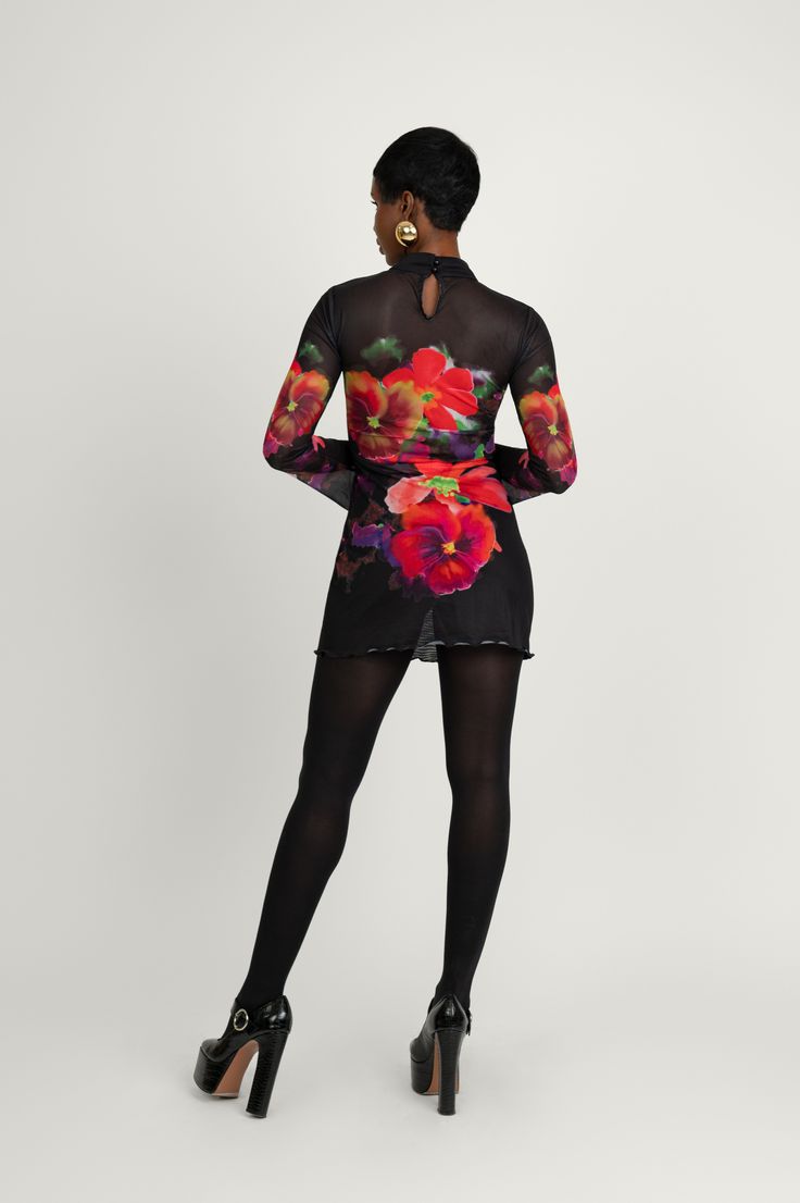 Miranda is the ultimate mini dress. Featuring a captivating all-over large romantic flower print and an A-line silhouette for a breezy flattering shape. This is the piece that you'll want to flaunt at special occasions this winter. Cut in sheer mesh fabric, it showcases long sleeves with stylishly flared cuffs and a short turtleneck collar. Pair this garment with your favorite high-heeled boots and our Nadia coat to top off the look. Sheer Long Sleeve Mini Dress For Cocktail, Long Sleeve Sheer Mini Dress For Fall, Sheer Mini Mesh Dress For Fall, Floral Print Mini Dress For Evening, Evening Floral Print Mini Dress, Fall Sheer Mesh Mini Dress, Floral Print Evening Mini Dress, Spring Long Sleeve Mesh Dress For Night Out, Fitted Floral Print Mini Dress For Winter