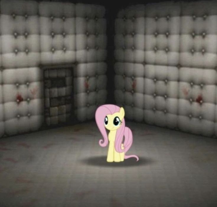 the pink pony is sitting in front of an empty room with mattresses on it