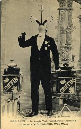 an old black and white photo of a man with tennis rackets on his head