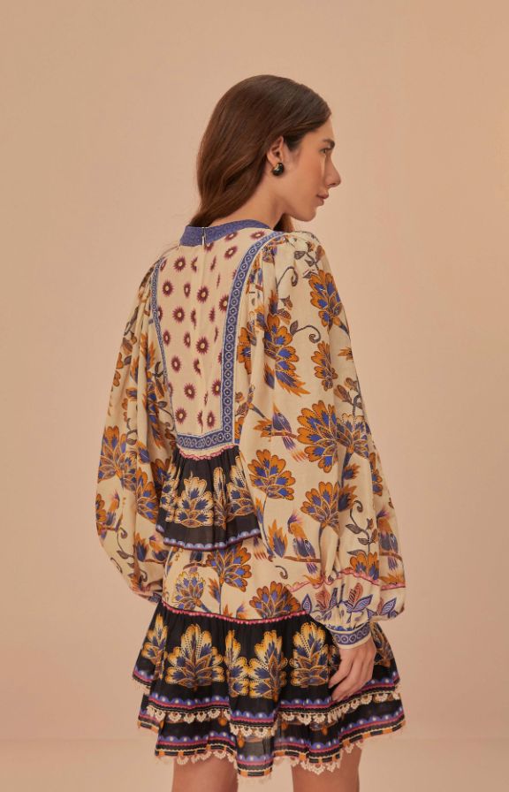 Embrace the essence of bohemian charm with the Cream Ainika Maxi Floral Blouse, crowned with a high neckline that enhances its elegant allure. Lush, earth-toned florals bloom across the fabric, harmonized by intricate detailing and contrasting geometric accents that frame the piece. Billowing sleeves and a relaxed, flowing silhouette invite a dance of movement, making this blouse a timeless piece that whispers stories of faraway places and warm, carefree days. Fit: Our Model Kristie is 5’8 and w Bohemian Flowy Dress With Blouson Sleeves, Bohemian Long Sleeve Blouse For Gatherings, Beige Bohemian Blouse With Boho Print, Flowy Bohemian Cream Blouse, Bohemian Floral Print Dresses For Gatherings, Long Sleeve Bohemian Dress With Baroque Print, Beige Bohemian Floral Print Tops, Bohemian Beige Floral Print Tops, Bohemian Blouse With Elastic Neckline For Spring