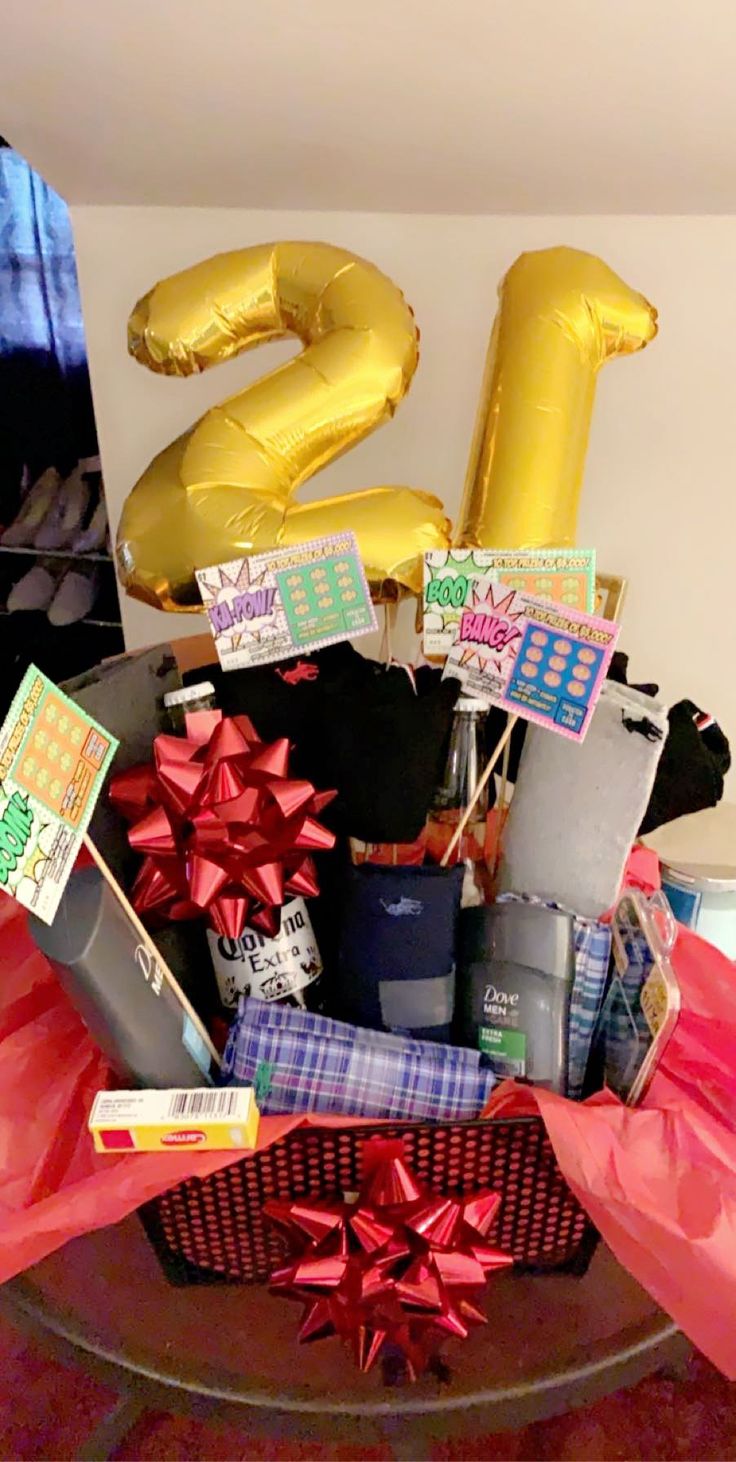 a birthday gift basket with balloons and gifts in the shape of number twenty five on it