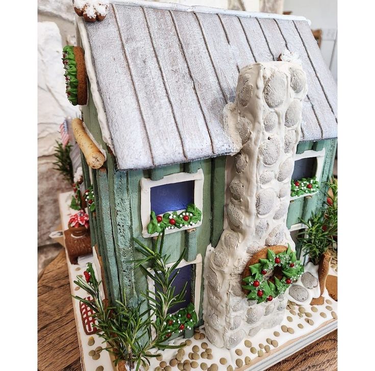 a house made out of clay and decorated with plants