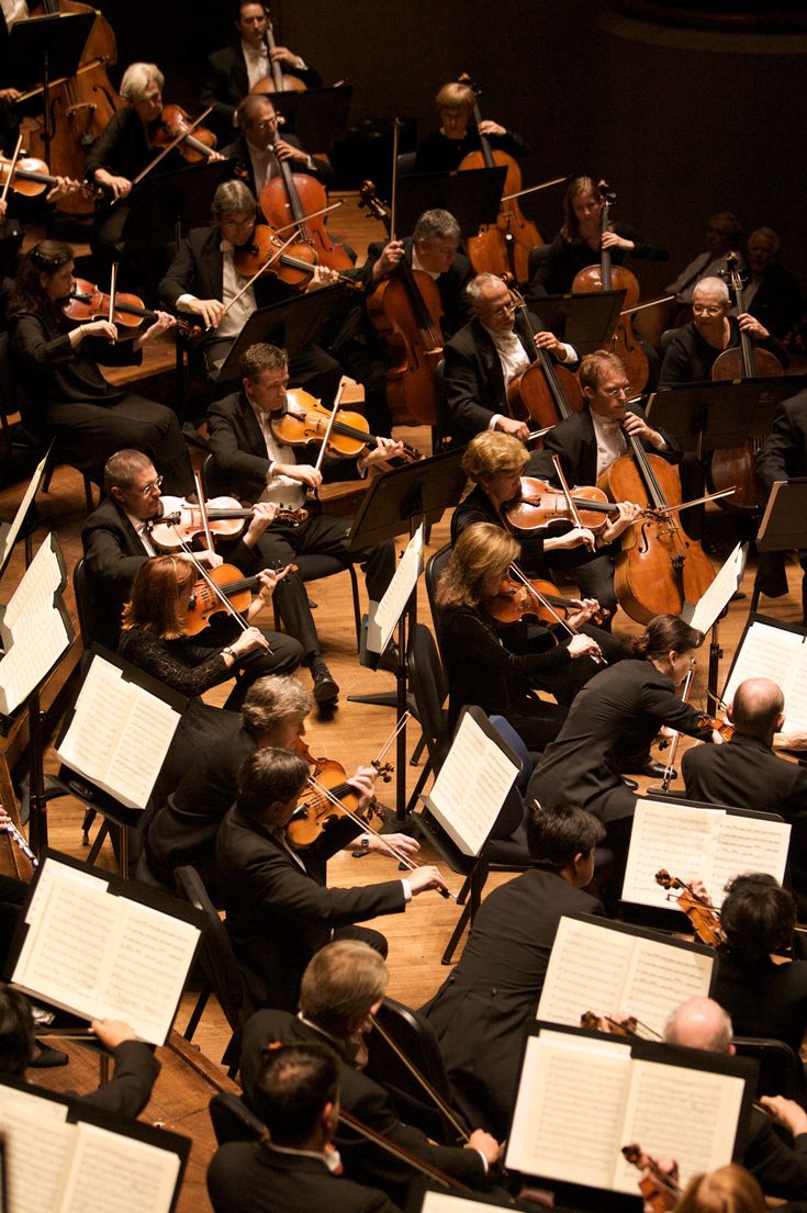 an orchestra with lots of people playing instruments