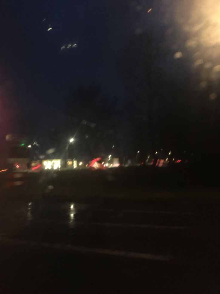 blurry image of street lights and cars at night