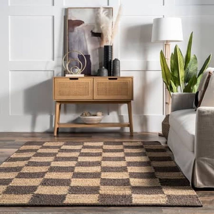 a living room with a checkered rug on the floor next to a couch and table