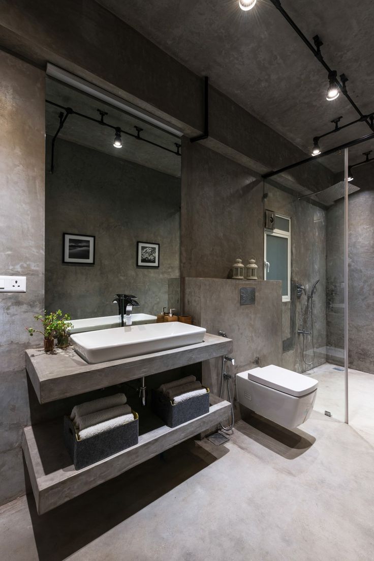 a bathroom with a sink, toilet and shower stall in it's own space